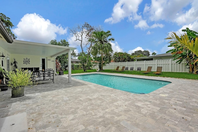 view of swimming pool with a patio area