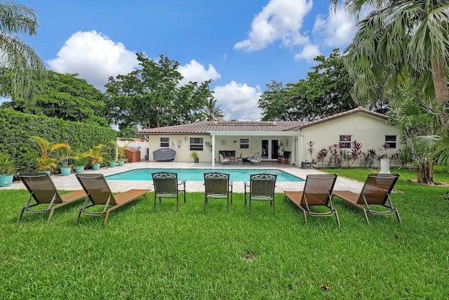 view of pool featuring a patio and a yard