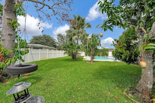 view of yard with a fenced in pool