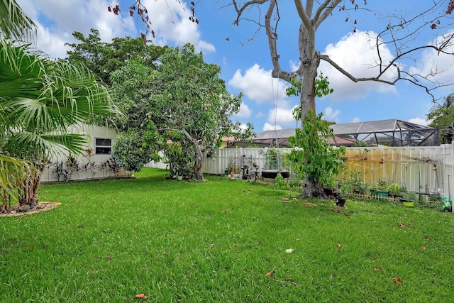 view of yard with glass enclosure