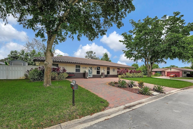 ranch-style house with a garage and a front lawn