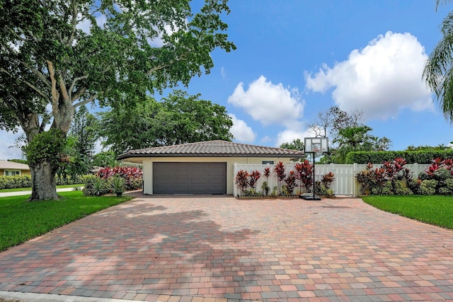 view of front of property featuring a garage and a front lawn