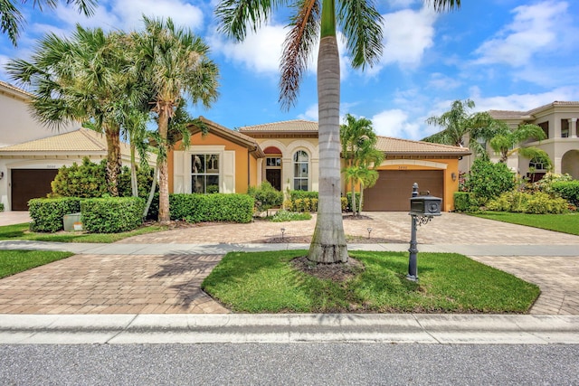 mediterranean / spanish-style home with a garage