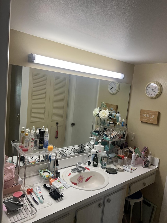 bathroom featuring vanity and a textured ceiling