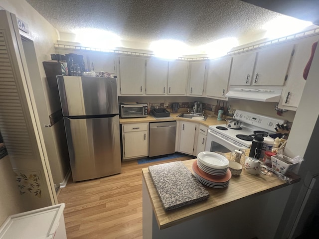 kitchen with white cabinetry, sink, stainless steel appliances, a textured ceiling, and light hardwood / wood-style flooring