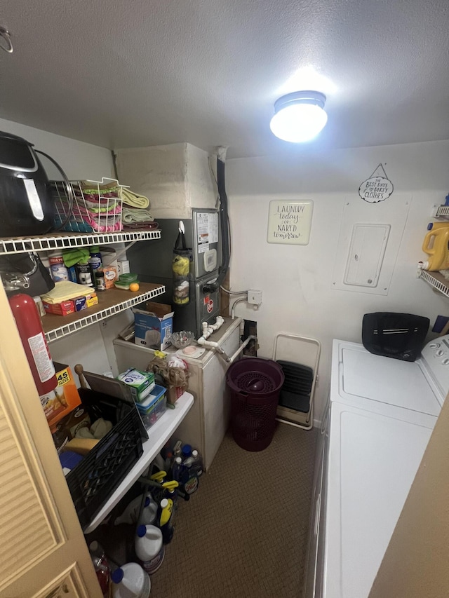 washroom featuring separate washer and dryer, carpet floors, and a textured ceiling