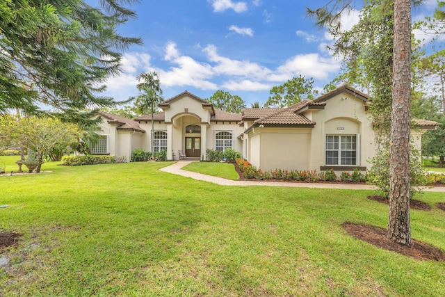 mediterranean / spanish house with a front lawn