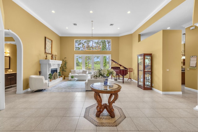 living room with light tile patterned flooring, a high ceiling, and ornamental molding