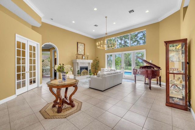 tiled living room with a premium fireplace, crown molding, and french doors