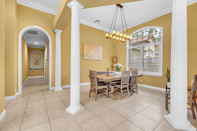 tiled dining space with ornate columns, an inviting chandelier, and crown molding