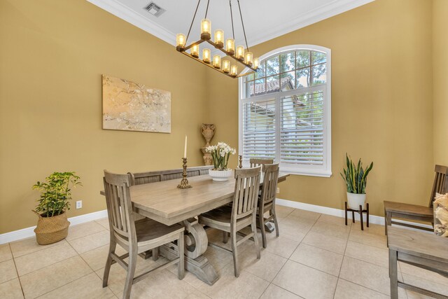 dining space featuring a notable chandelier, crown molding, and light tile patterned floors