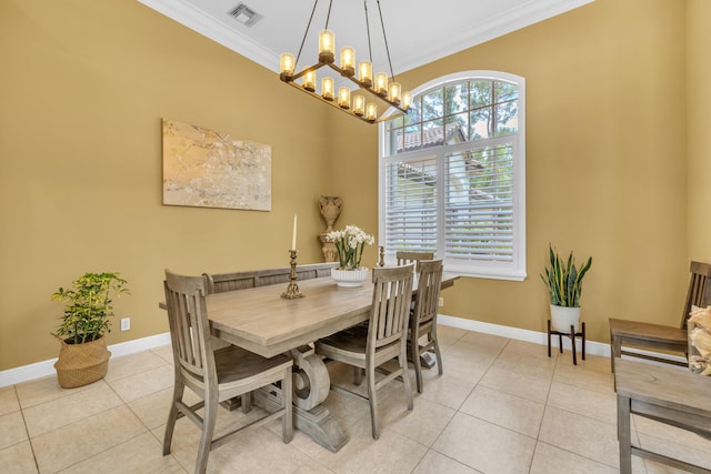 tiled dining room with ornamental molding and a notable chandelier