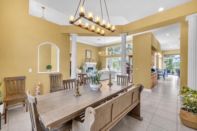 dining room featuring plenty of natural light, decorative columns, and light tile patterned floors