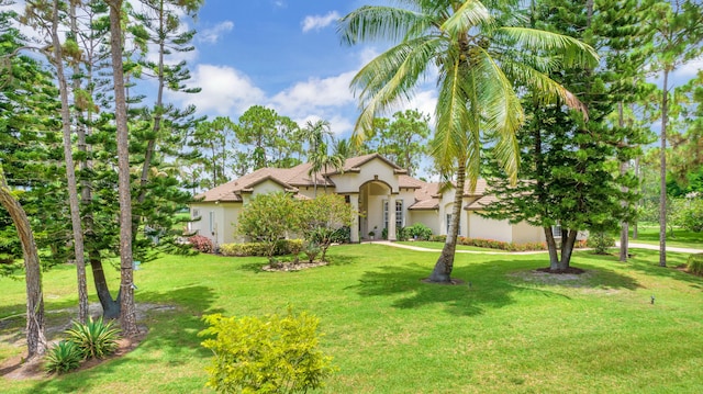 mediterranean / spanish house featuring a front lawn