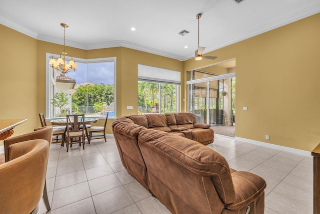 tiled living room with ceiling fan with notable chandelier and ornamental molding