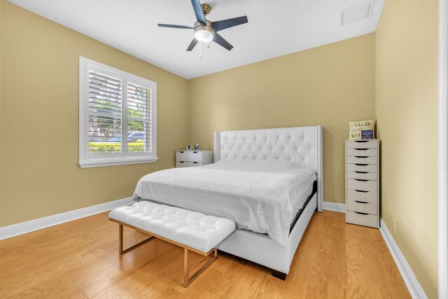 bedroom with ceiling fan and light hardwood / wood-style flooring