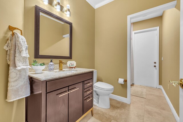 bathroom with ornamental molding, vanity, tile patterned floors, and toilet