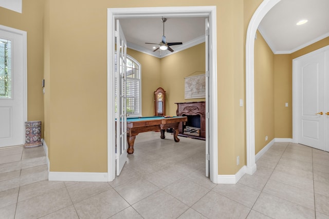 playroom with billiards, ornamental molding, ceiling fan, and light tile patterned flooring