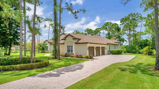 view of front of home featuring a garage and a front lawn