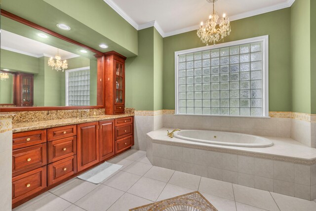 bathroom featuring vanity, tile patterned floors, tiled tub, ornamental molding, and an inviting chandelier