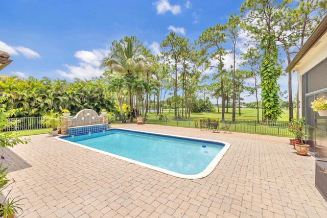 view of pool featuring a patio and a lawn