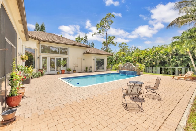 view of pool with a patio area and french doors