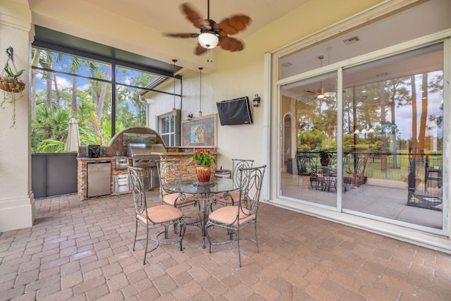 sunroom / solarium featuring ceiling fan