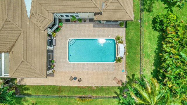 view of pool featuring a lawn