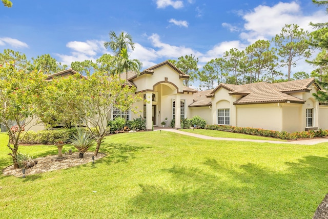 mediterranean / spanish-style house with a front lawn