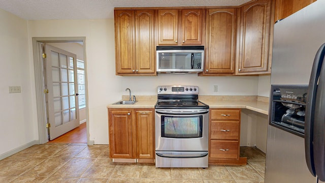 kitchen featuring sink, stainless steel appliances, and light hardwood / wood-style floors