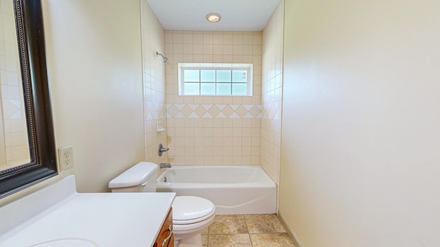 full bathroom with tile patterned flooring, toilet, vanity, and tiled shower / bath