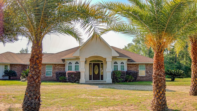 ranch-style home with a front lawn