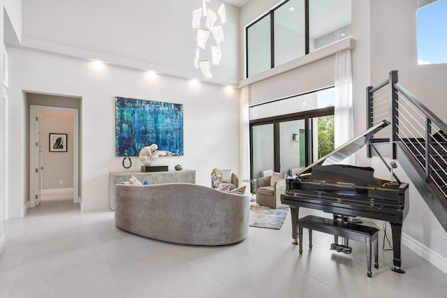 living area featuring a high ceiling and tile patterned flooring