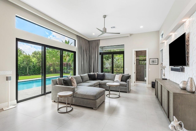 living room with ceiling fan and a wealth of natural light