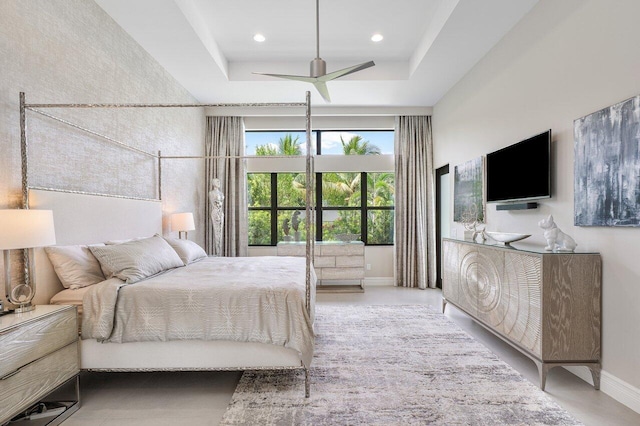 bedroom featuring a raised ceiling and ceiling fan