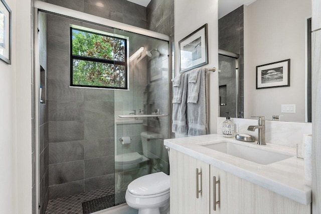 bathroom with vanity, toilet, and walk in shower