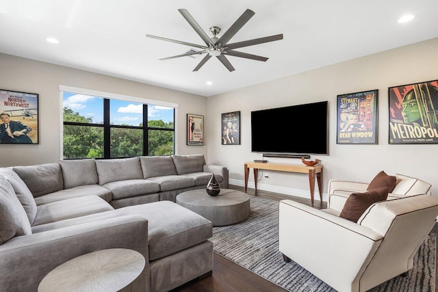 living room featuring dark hardwood / wood-style floors and ceiling fan