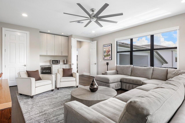 living room with wine cooler, dark hardwood / wood-style floors, and ceiling fan