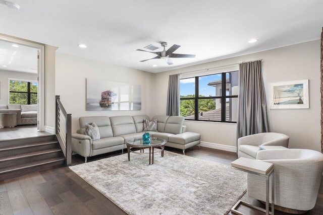 living room with ceiling fan, a wealth of natural light, and dark hardwood / wood-style flooring