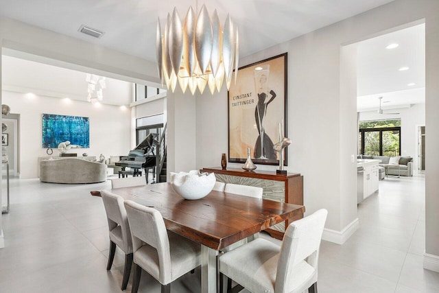 tiled dining area with a chandelier