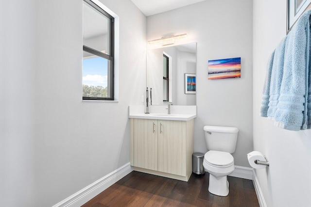 bathroom featuring vanity, toilet, and hardwood / wood-style floors