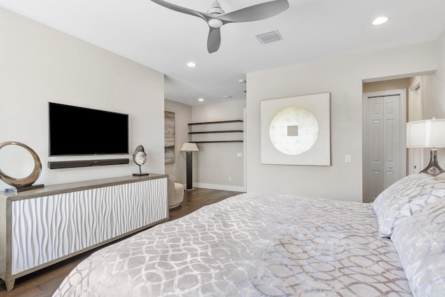 bedroom featuring a closet, dark wood-type flooring, and ceiling fan