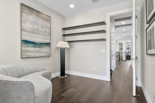 sitting room with dark wood-type flooring