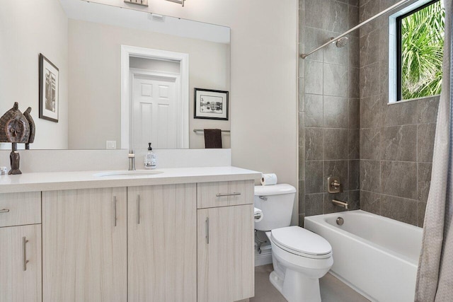 full bathroom with tiled shower / bath, vanity, and toilet