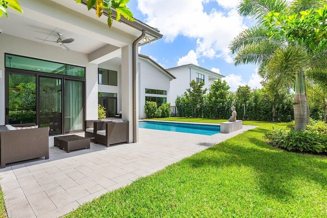 view of swimming pool with an outdoor hangout area, a yard, a patio, and ceiling fan