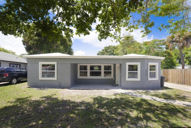 single story home with a patio and a front lawn