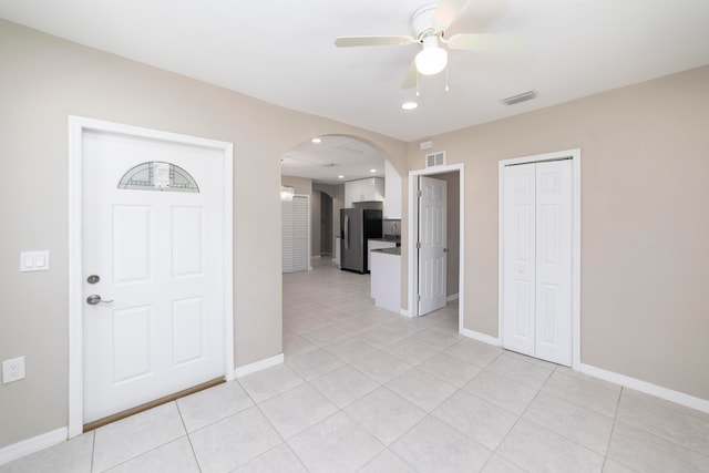 tiled entryway with ceiling fan