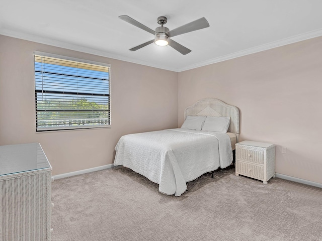 carpeted bedroom with crown molding and ceiling fan