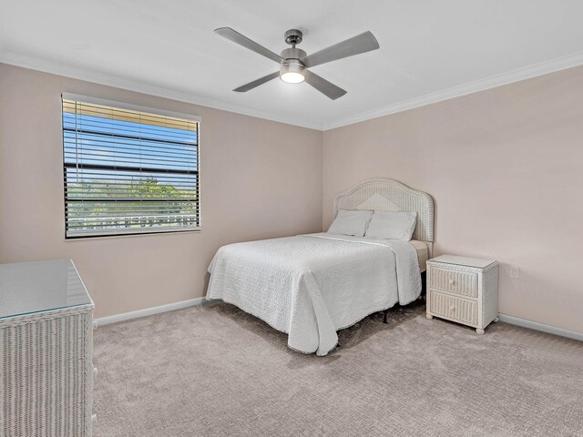 bedroom with crown molding, ceiling fan, and light carpet