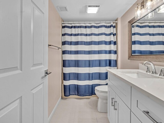 bathroom with vanity, a shower with shower curtain, tile patterned floors, and toilet